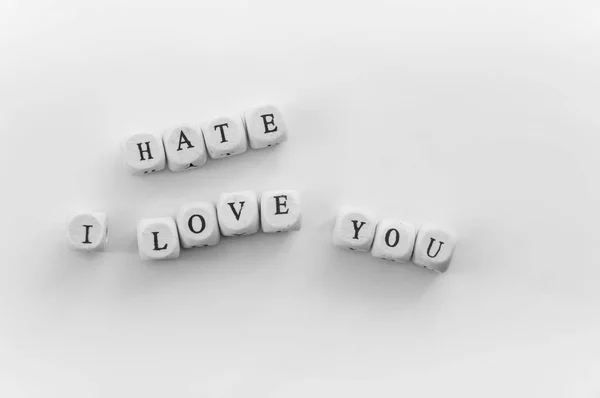 words hate and i love you on dices on white background