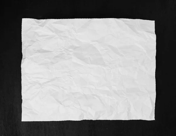 crumpled white sheet on black background