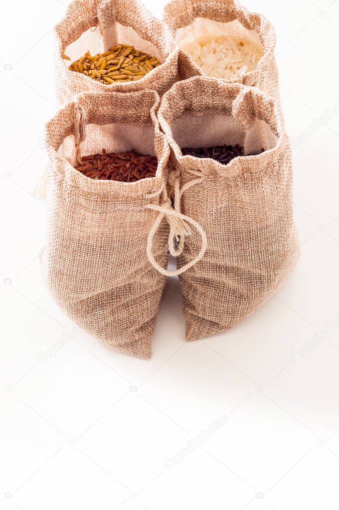 Set of different types of rice and oat in sacks isolated on white background