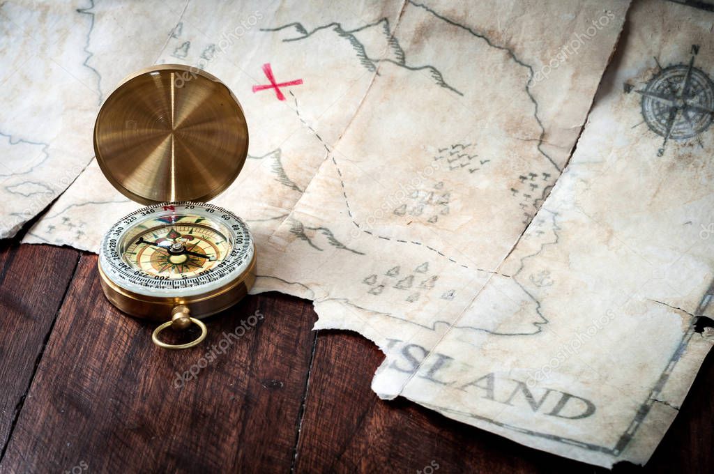 Compass and map of island with treasure sign 