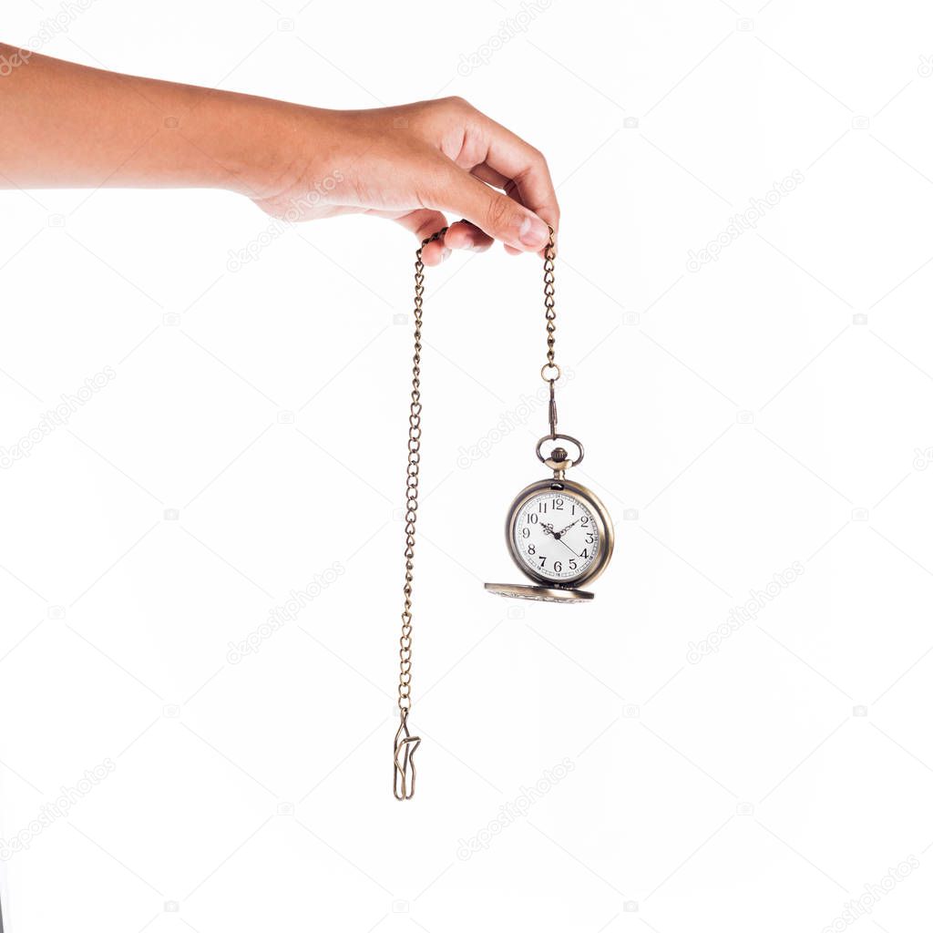 female hand holding vintage clock on chain