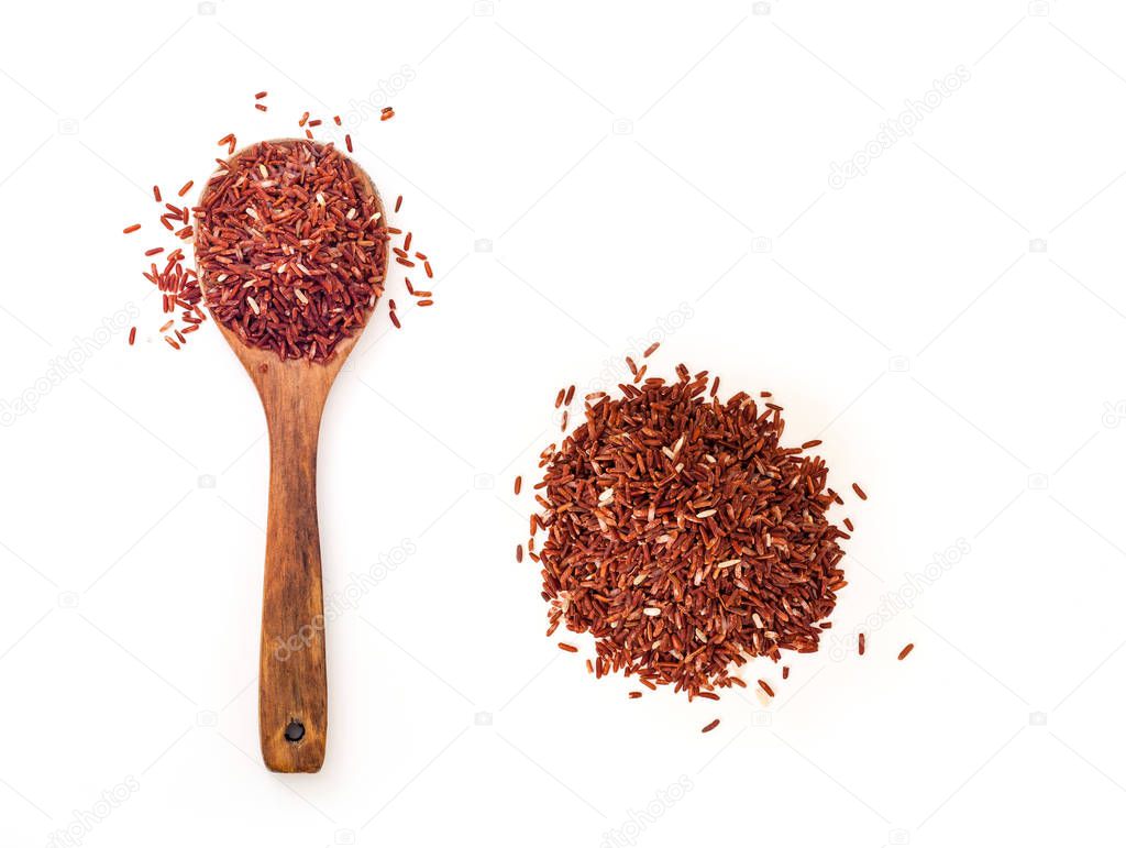 top view of brown uncooked rice in wooden spoon near pile of grains isolated on white background 