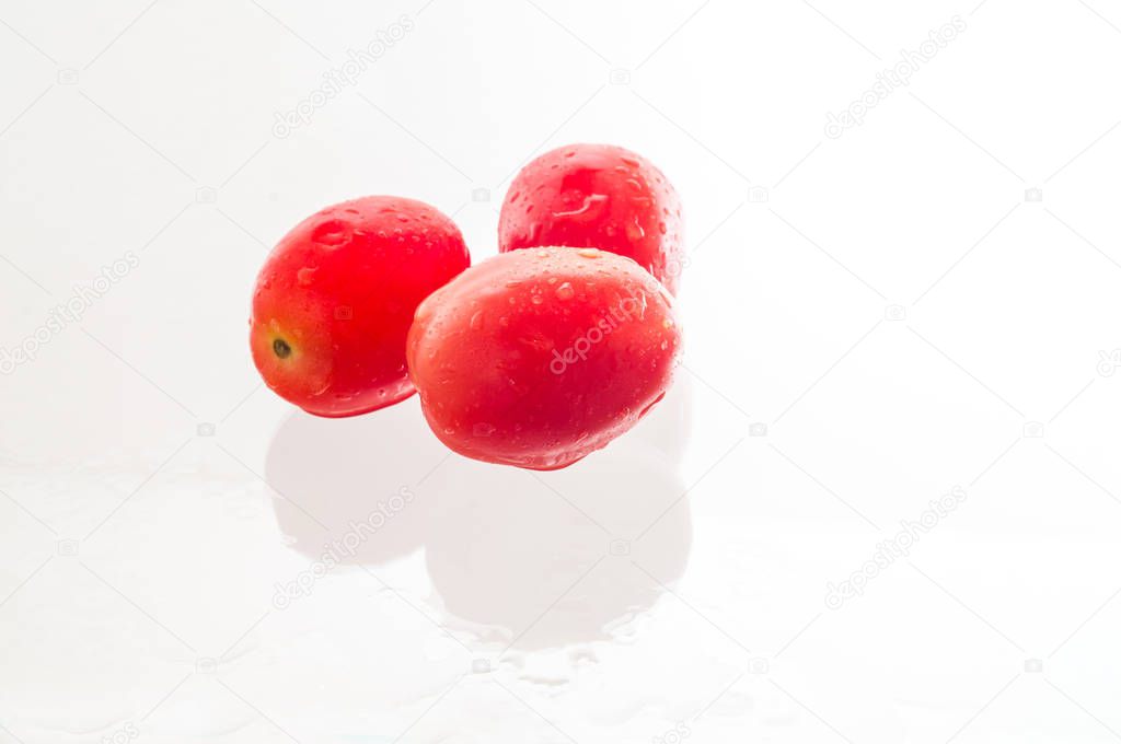 Red cherry grape tomatoes isolated on white background