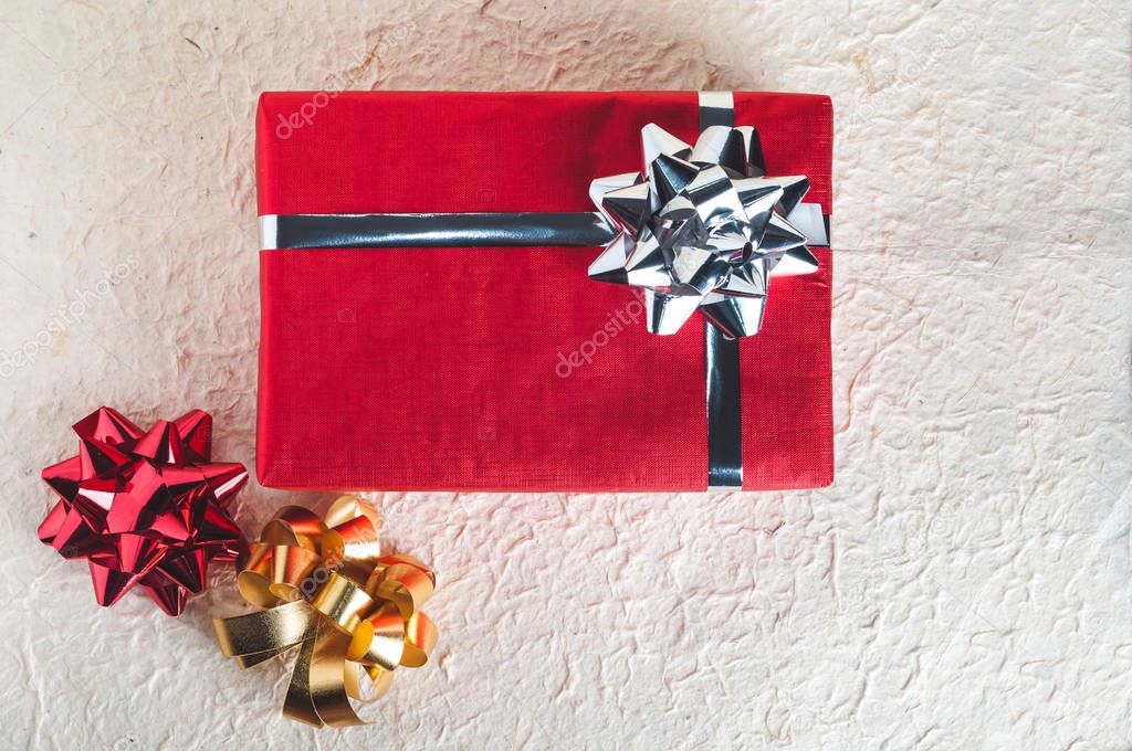top view of red gift box with different bows