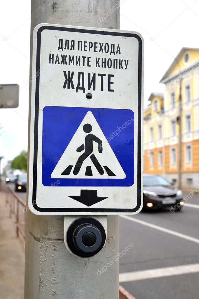The button for switching of the traffic light at the crosswalk. The Russian text - For transition press the button, wait 