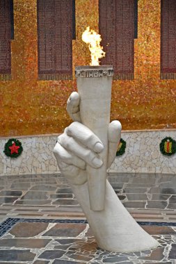 VOLGOGRAD, RUSSIA - APRIL 23, 2017: An eternal flame in the Hall of Military glory. Mamayev Kurgan clipart
