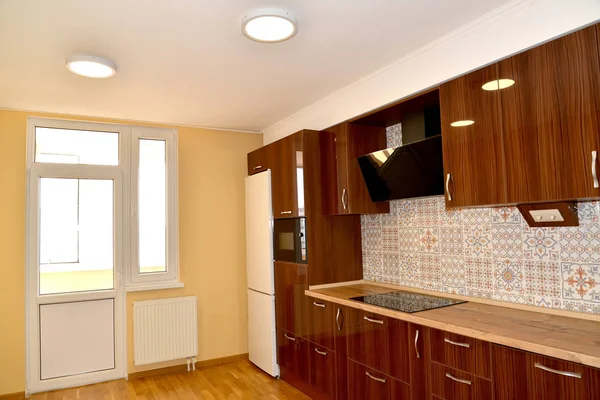 Premises of kitchen with the built-in furniture and a balcony door — Stock Photo, Image