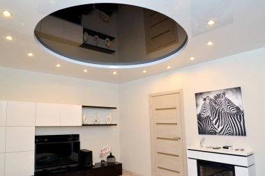 The central design of a glossy stretch ceiling in a living room interior clipart