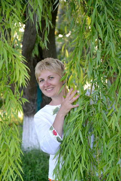 Žena Středního Věku Dívá Přes Vrbové Větve — Stock fotografie