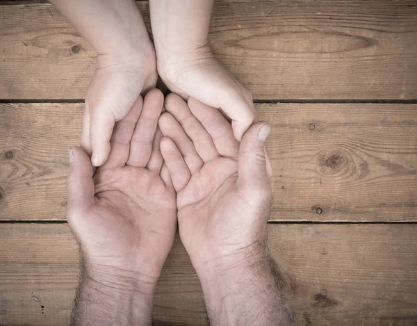 Senioren en jongeren hand in hand — Stockfoto