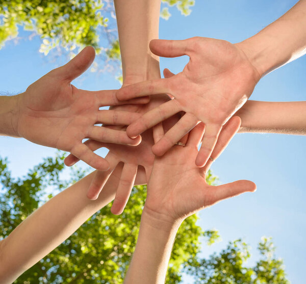 volunteers people hands together outdoors