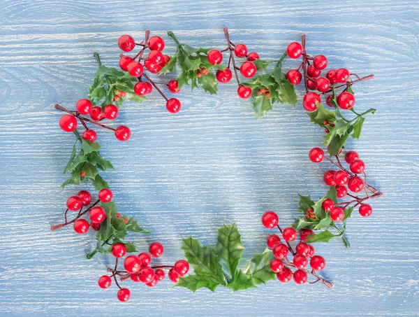 Weihnachten Hintergrund mit Kranz aus roter Stechpalme auf Holzboden — Stockfoto