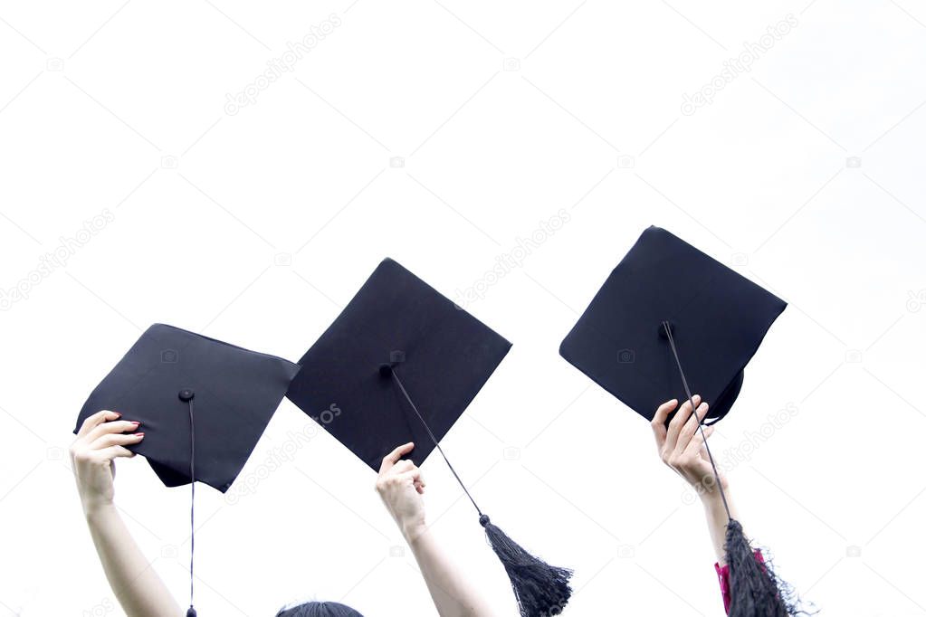 Holding graduation hats background