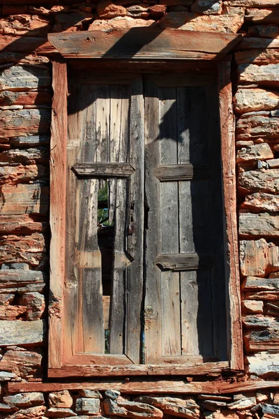 stone wall and broken old wood door