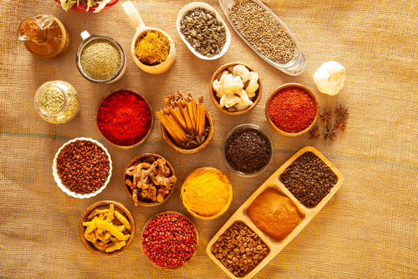 Various spices and herbs as a background.