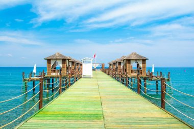Ahşap beach pavyonlar kıyısında kumlu bir plaj - Akdeniz kıyılarında, Beldibi, Antalya, Türkiye
