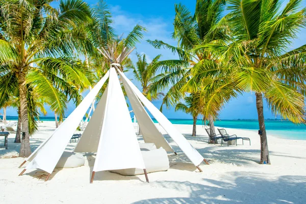 Chill lounge zone with a tent and seating areas in luxury hotel on the shore of Indian Ocean, Maldives