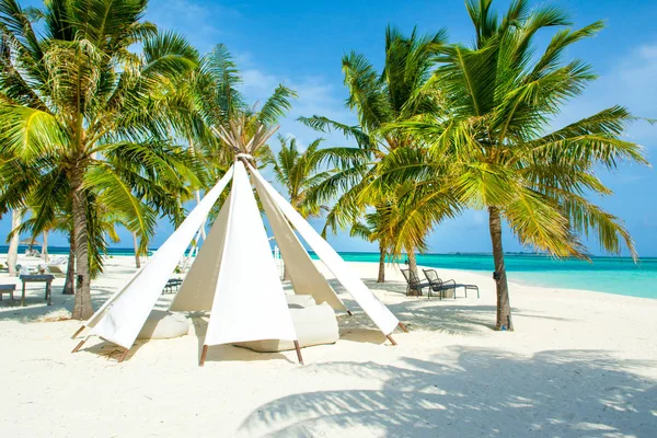 Chill lounge zone with a tent and seating areas in luxury hotel on the shore of Indian Ocean, Maldives