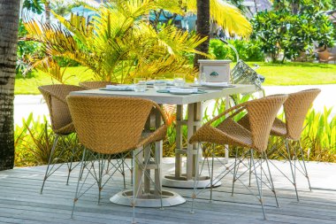 Tablo tropikal restoranın açık rattan sandalye ile servis 