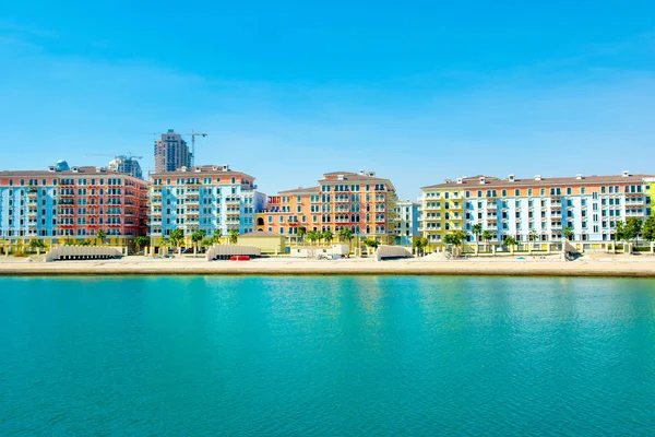 Colorful waterfront buildings in venetian style of the Qanat Quartier in the Pearl Qatar