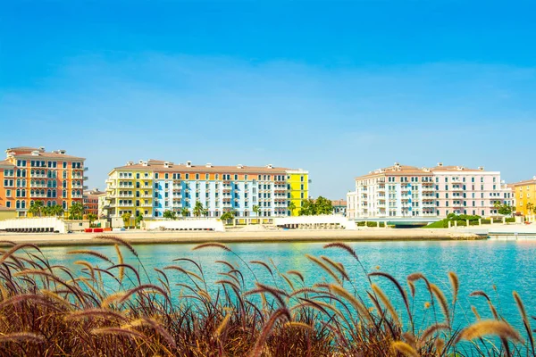 Colorful waterfront buildings in venetian style of the Qanat Quartier in the Pearl Qatar