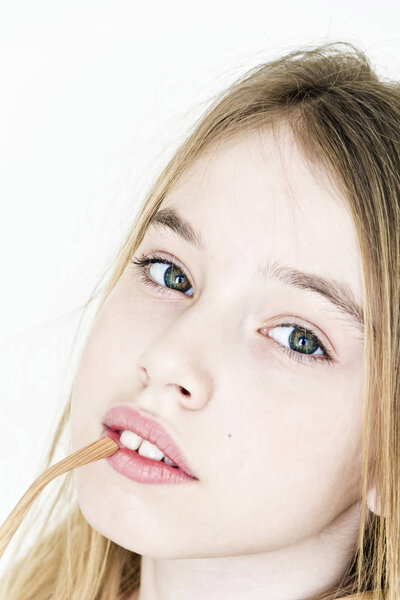 Cute teenager girl with big eyes on white wall