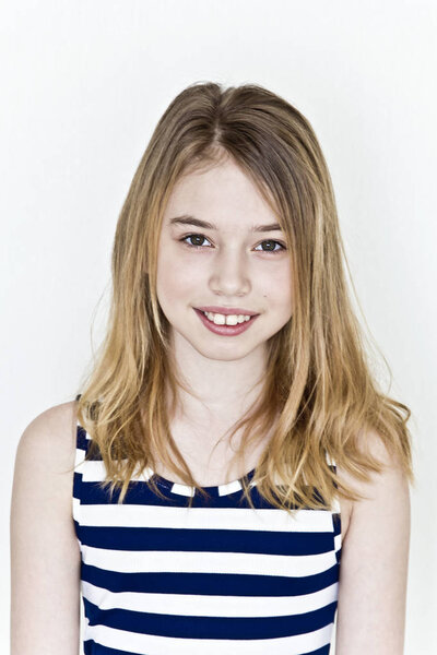Cute girl eleven years old with blond long hair on white background