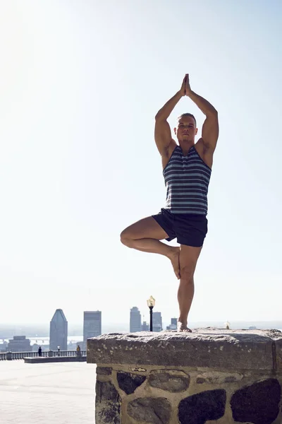 Male yoga enthusiast in tree pose, Montreal, Quebec, Canada