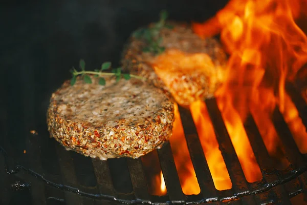 炎のバーベキュー グリルにミントとラムで味付けラム肉ハンバーガーをこする — ストック写真