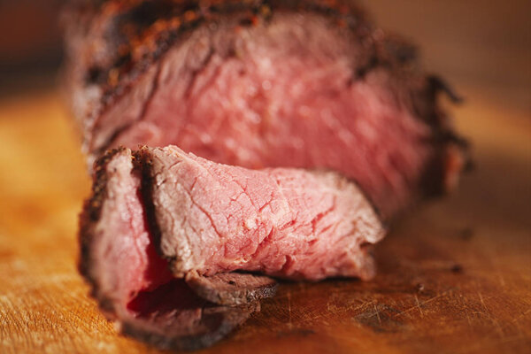 Roast beef steak, perfectly grilled on wooden background