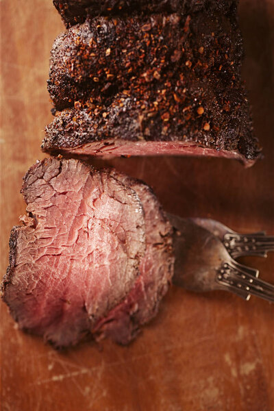 Roast beef steak, perfectly sous vide cooked and grilled on wooden background
