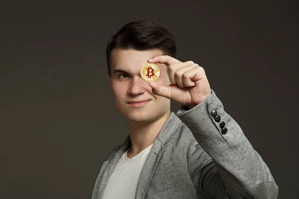 Portrait Young Guy Jacket Bitcoin Coin His Hand Gray Background — Stock Photo, Image