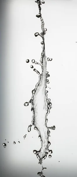 Water splash with a lot of drops on a gray background — Stock Photo, Image