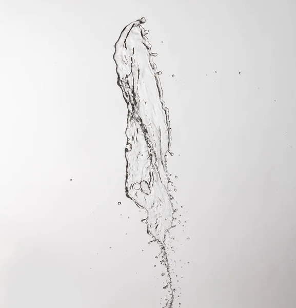 Salpicadura de agua con un montón de gotas sobre un fondo gris —  Fotos de Stock