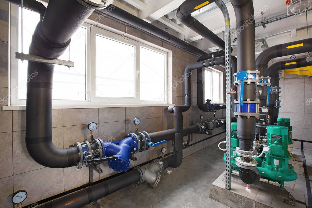 interior of industrial, gas boiler room with boilers; pumps; sensors and a variety of pipelines.