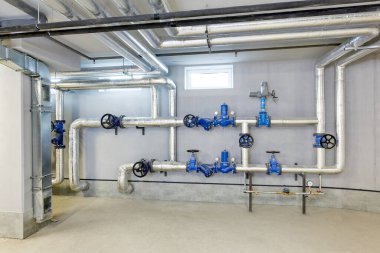 Birçok boru ve vanası olan endüstriyel bir kazan dairesinin mühendislik tasarımları..