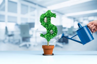 Dollar income growth concept. Income growth represented by plant in shape of dollar symbol watered by CFO, investor, stockholder and similar business person.