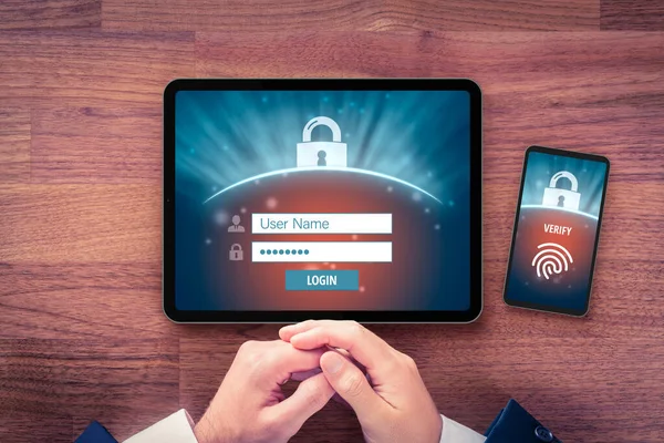 Two-factor authentication (2FA) and fingerprint touch identification security concept. User with digital tablet and smart phone and two-factor authentication security process, flatlay design.