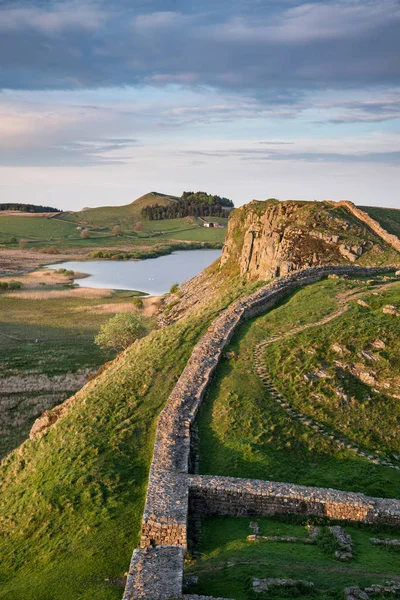 Stunning landscape image of Hadrian\'s Wall in Northumberland at sunset with fantastic late Spring light