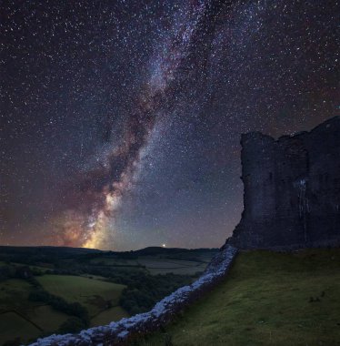Stunning vibrant Milky Way composite image over landscape of medieval castle ruins clipart