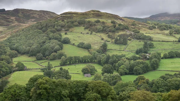 Beautiful landscape image of view from Precipice Walk in Snowdonia overlooking Barmouth and Coed-y-Brenin forest during rainy afternoon in September