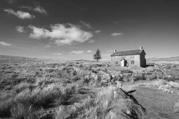 Beautiful black and white landscape image of Nun\'s Cross Farm in Dartmoor