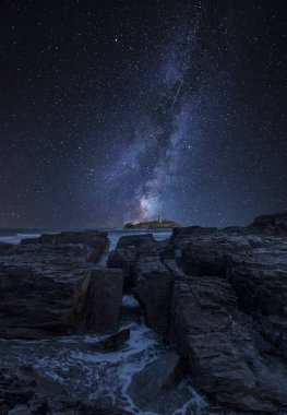 Godrevy deniz feneri İngiltere'de Cornwall sahil şeridi üzerinde peyzaj üzerinde çarpıcı Canlı Samanyolu bileşik görüntü