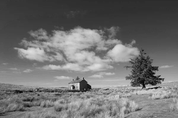 Beautiful black and white landscape image of Nun\'s Cross Farm in Dartmoor