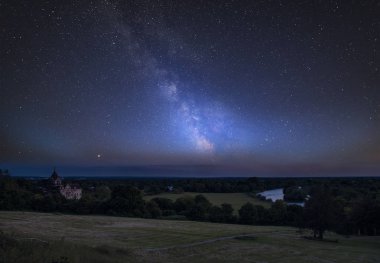 Stunning vibrant Milky Way composite image over landscape of River Thames on Richmond Hill in London. clipart