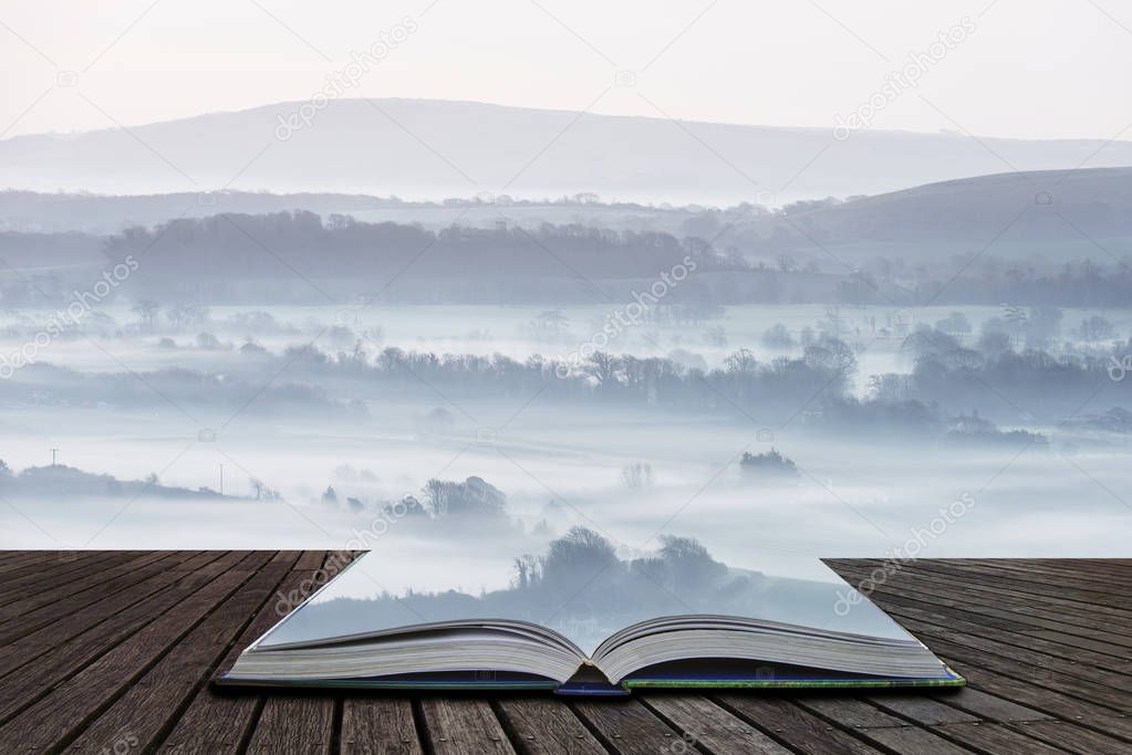 Stunning foggy English rural landscape at sunrise in Winter with