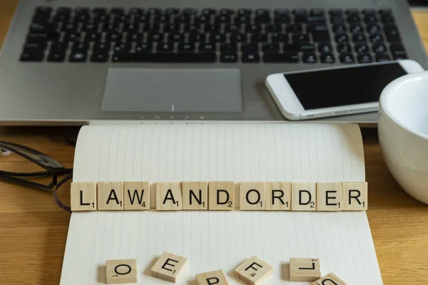 Concept keyword law and order in wooden tile letters  in persona — Stock Photo, Image