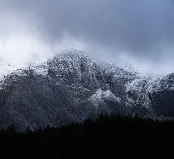 Stunning dramatic landscape image of snowcapped Glyders mountain