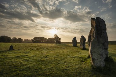 Stunning Summer sunrise landscape of Neolithic standing stones i clipart