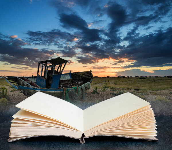 Digital composite concept image of open book wth Abandoned fishing boat on shingle beach landscape at sunset